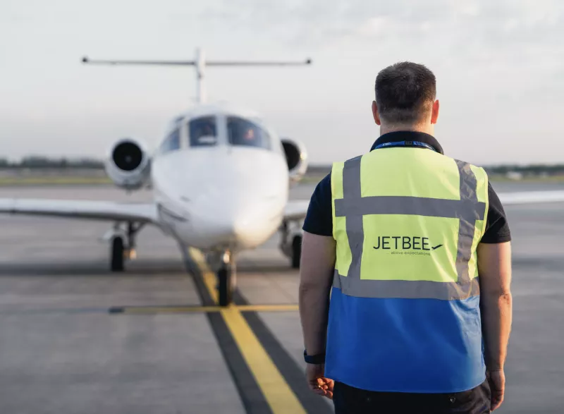 Ground operation manager in front of a private jet